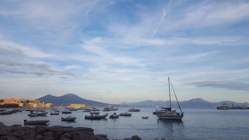 Sailboats in sea against sky