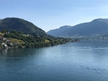 Scenic view of lake and mountains against clear sky