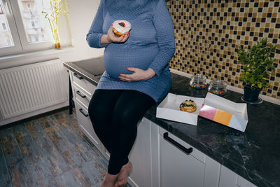 Full length of woman standing at home