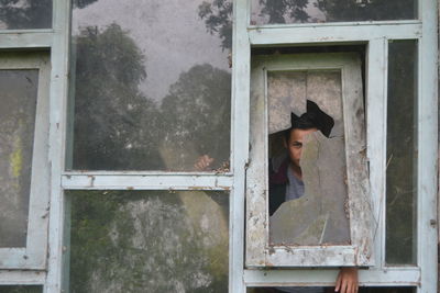 Portrait of woman standing by window