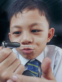 Close-up of boy holding car key