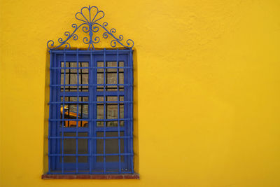 Close-up of yellow window on wall