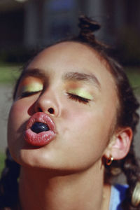 Close-up of girl sucking candy