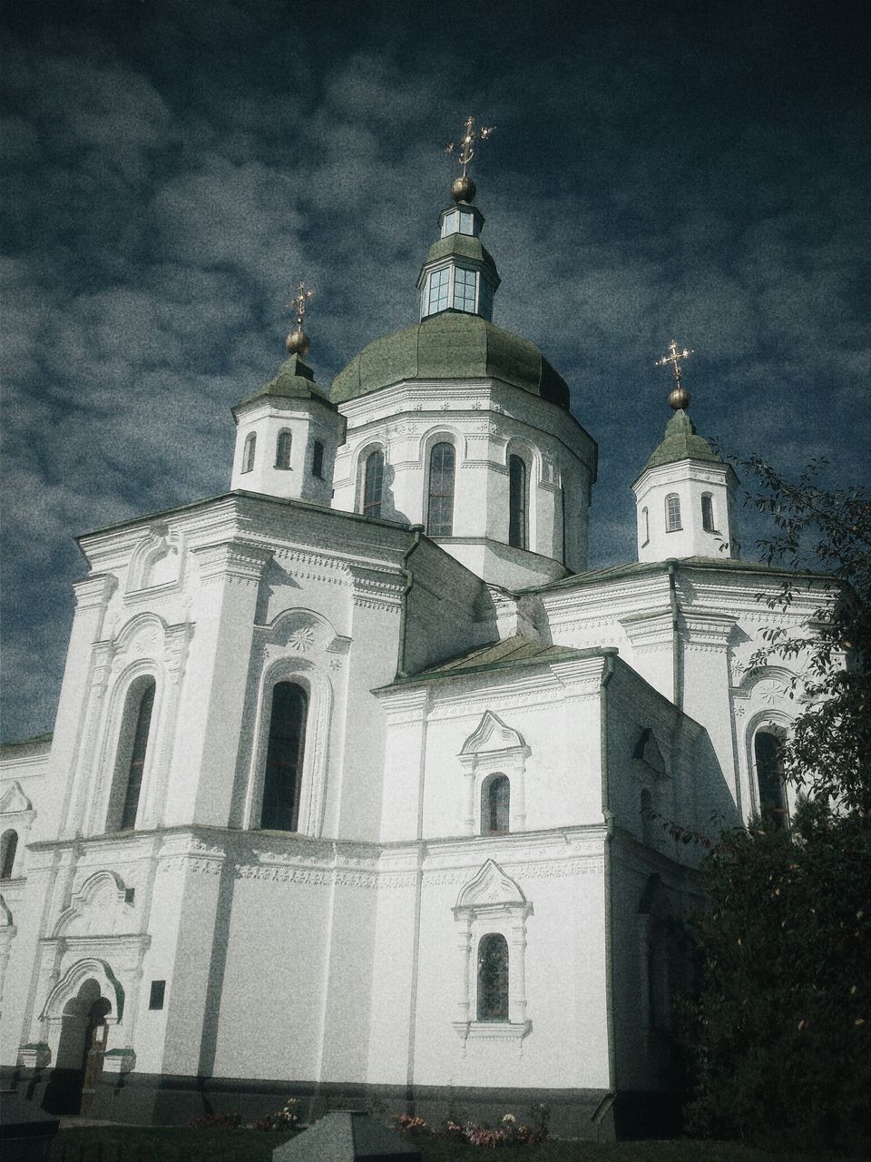 religion, church, place of worship, building exterior, architecture, spirituality, built structure, cross, cathedral, sky, low angle view, dome, tower, steeple, cloud - sky, facade, outdoors, tree