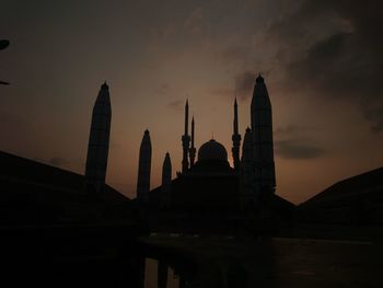 Silhouette temple against sky during sunset