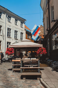 Potted plants on street against buildings in city