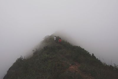 Scenic view of landscape against sky during foggy weather