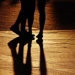 Low section of silhouette people standing outdoors