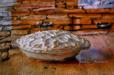 Close-up of bread on table against wall