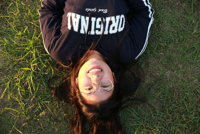 High angle view of woman lying on field