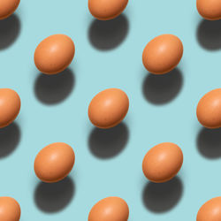 Close-up of orange eggs against white background