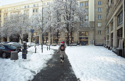 Snow covered street in city during winter