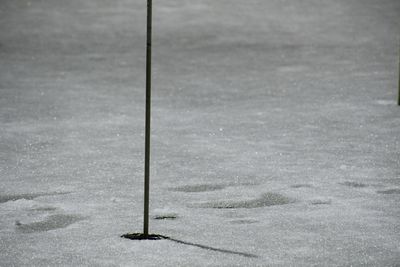 High angle view of pole on field by water