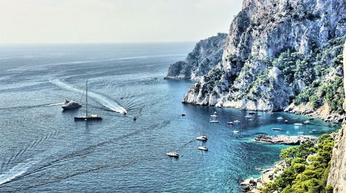 High angle view of sailboats on sea shore against sky