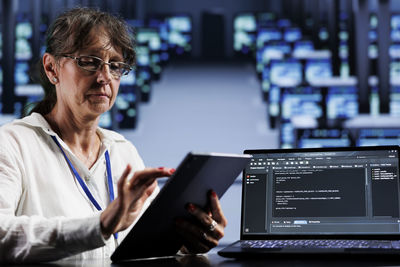 Midsection of woman using laptop