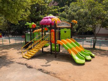 View of playground against trees in park