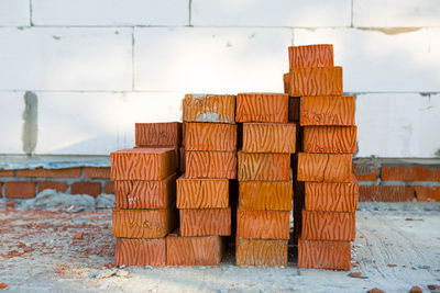 Close-up of stack of wood against wall