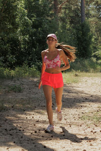 Full length of young woman standing on field