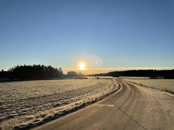 Scenic view of landscape against clear sky during sunset