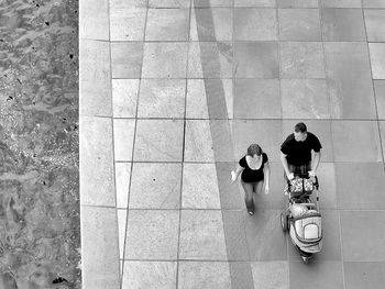 High angle view of people walking on footpath