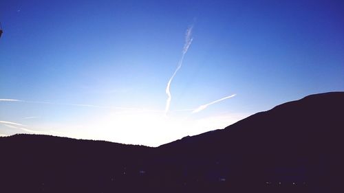 Low angle view of mountain against blue sky
