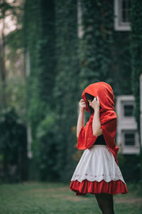 Rear view of woman with red umbrella