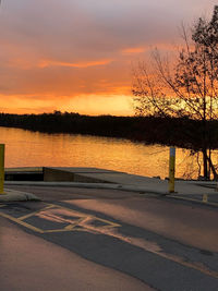 Scenic view of lake against orange sky