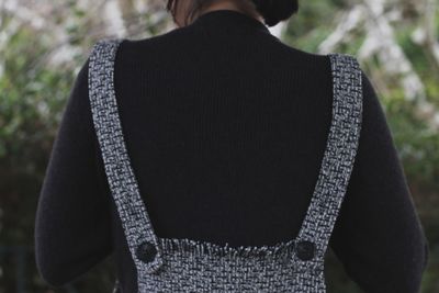 Rear view of woman standing against blurred background