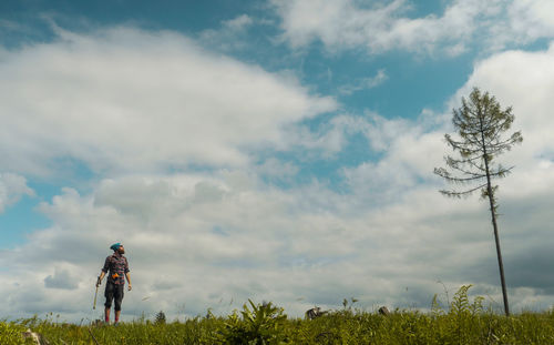 Man standing on field against sky