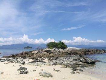 Rocks on beach against sky