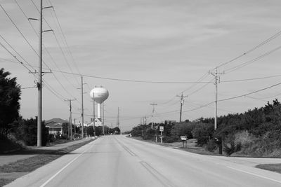 Empty road against cloudy sky