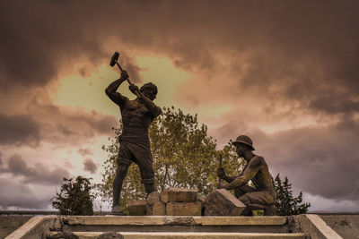 Low angle view of statue against sky during sunset