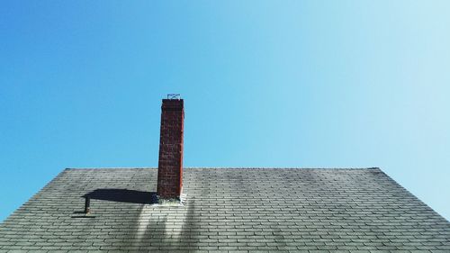 Low angle view of building against clear blue sky