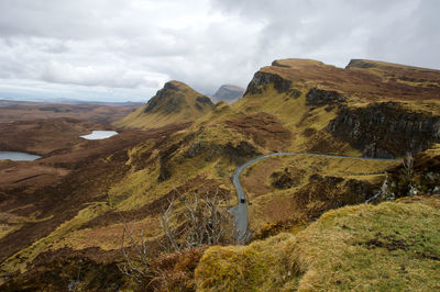 Scenic view of mountains against cloudy sky