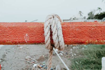 Close-up of rope on field against clear sky