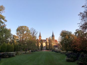 View of temple amidst buildings against sky