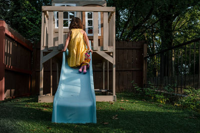 Young girl playing on a slide outdoors