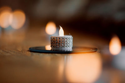 Close-up of illuminated candles on table