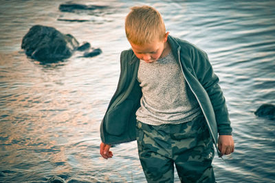 Rear view of boy looking at sea