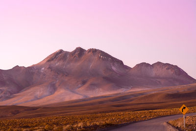 Road and road sign in the altiplano, high andean plateau, atacama desert, chile, south america