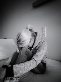 Woman sitting on sofa at home