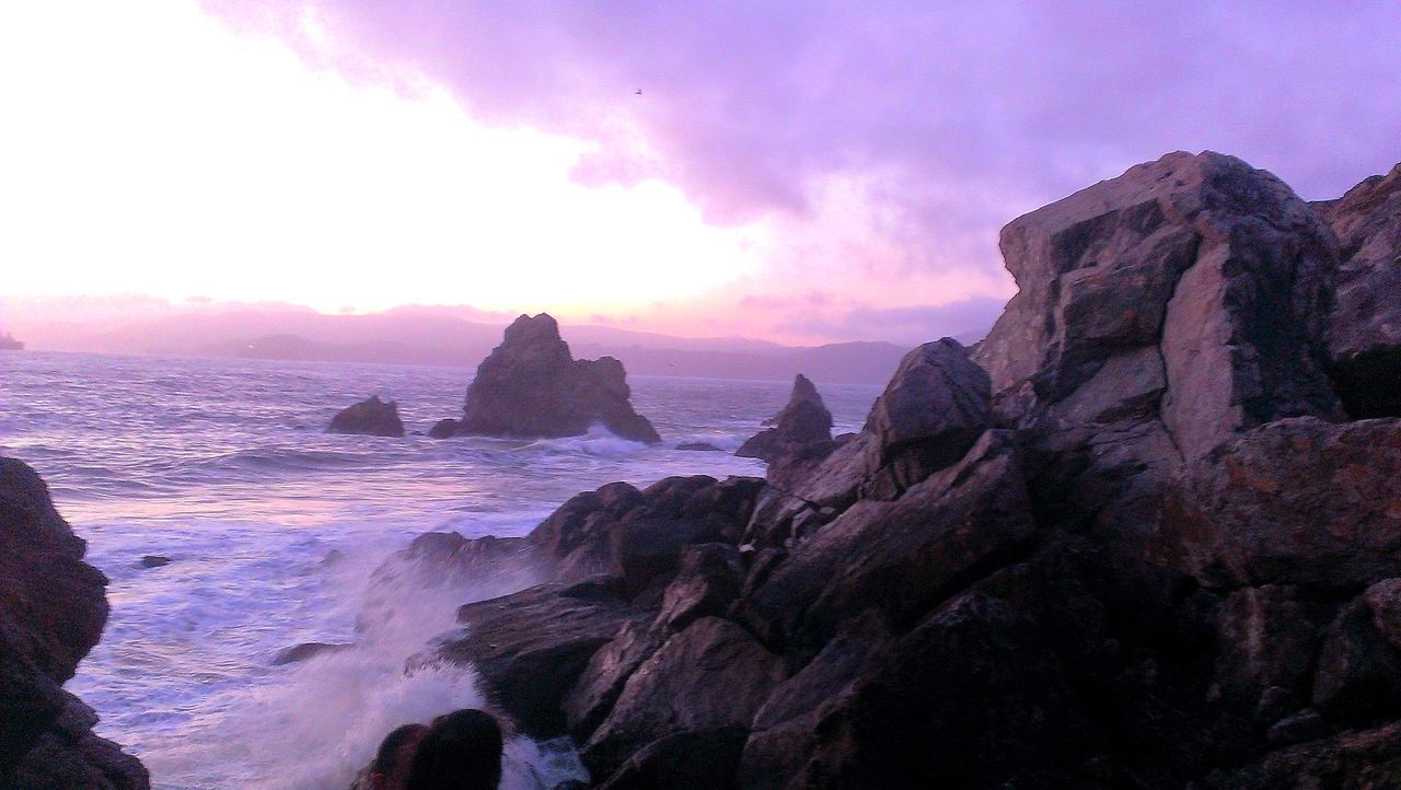 ROCK FORMATION ON SEA AGAINST SKY