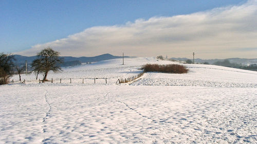 Scenic view of snow covered landscape against sky