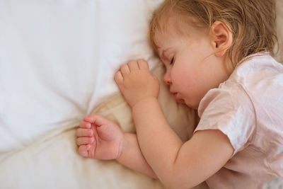 Peaceful adorable baby sleeping on his bed at home. sleeping newborn baby concept. one year old baby