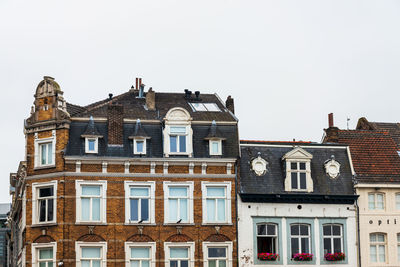 Low angle view of buildings in town against sky