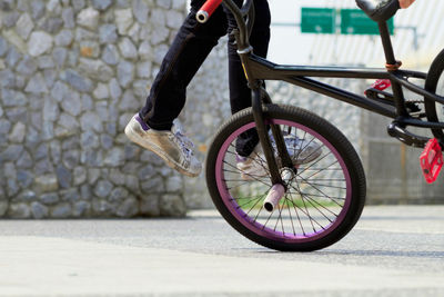 Low section of man riding bicycle on street