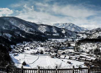 Scenic view of snow covered houses in shirakawa against sky