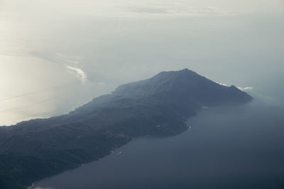 Scenic view of sea and mountains against sky