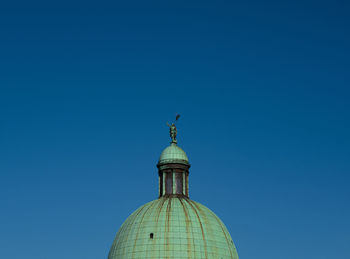 Low angle view of building against clear blue sky