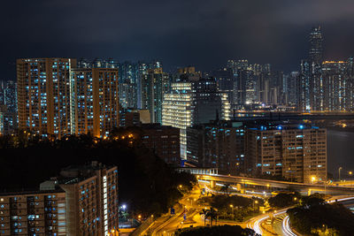 High angle view of illuminated buildings against sky at night